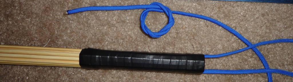 Loosely wrap 4 turns of paracord around the handle and note length Make a loop with the free end about 1.