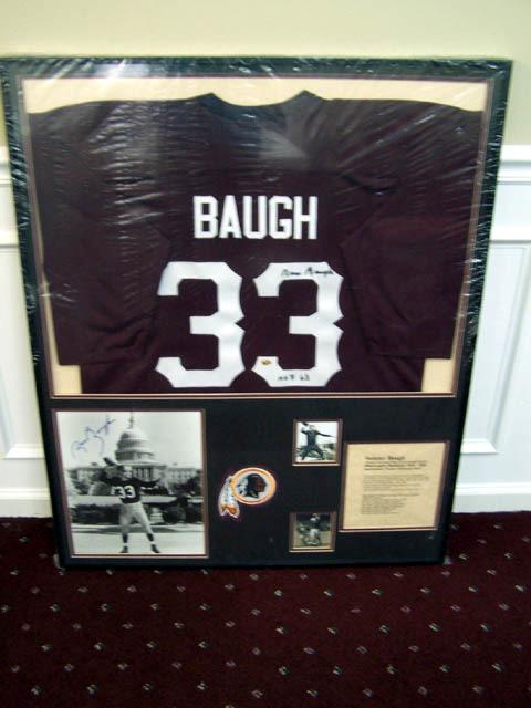 Item #BP10-18 Sammy Baugh Matted and framed, this piece features a signed jersey and 11x14 of NFL and Washington Redskin s legend Slingin Sammy Baugh.