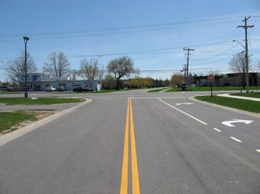 approach at Pine Trail. The Village Square Boulevard approach contains one northbound lane and two southbound lanes. West Main Street and Pine Trail are both two-lane roads.