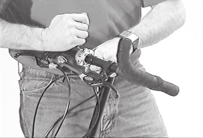 Make certain the attached cables are not tangled or wrapped around the frame or fork. Insert left handlebar into stem clamp, then right bar. 32.