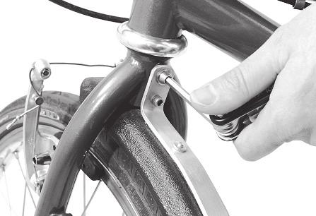 The fender is attached to the fork by the upper hole, while the alignment pin keeps the fender from rotating. Fig. 1 Front fender. 2.