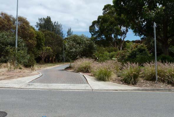 Local Area Traffic Management A driveway entry constructed on a terminating leg of a T-intersection should give the appearance of a single straight road with a private driveway where the terminating