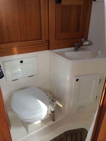 compartment to starboard Electric shower drain pump Portlight with curtains Aft heads compartment