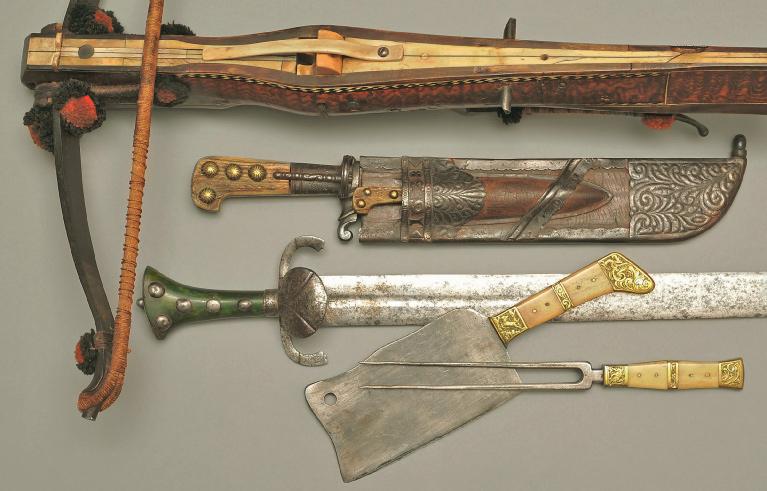 Hunting crossbow, German dated 1551. Tiller partly panelled with bone and walnut, original bowstring, cord bridle and woollen pompoms. Hunting cleaver, German dated 1638.