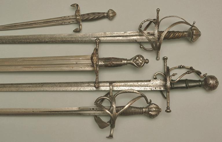 Dagger, Italy around 1560. Pierced blade, guard with engraved iron acanthus. Rapier, Italy around 1560. Blade with knotted cross mark, guard and pommel with iron engraving. Sword, Italy around 1560.