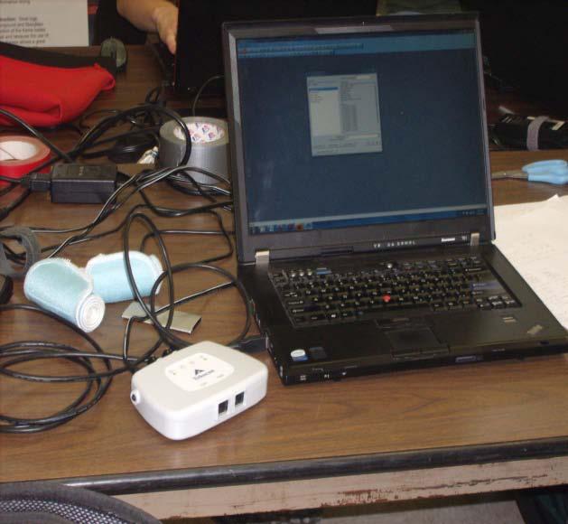 Figure 3: Experimental setup with the F-Scan System pressure sensors and wireless hardware (by Tekscan) on user interface and user on the left, and on the right the wireless hub connected to the