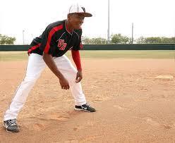 stance) (2) with their left foot on the side of the base and