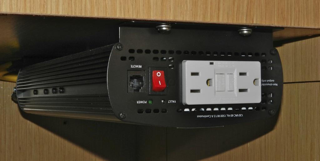 The inverter is located underneath the charter table and is turned on by a red switch on its face.