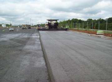 drum rollers, which leaves a final surface appearance similar to asphalt, except the color is gray.