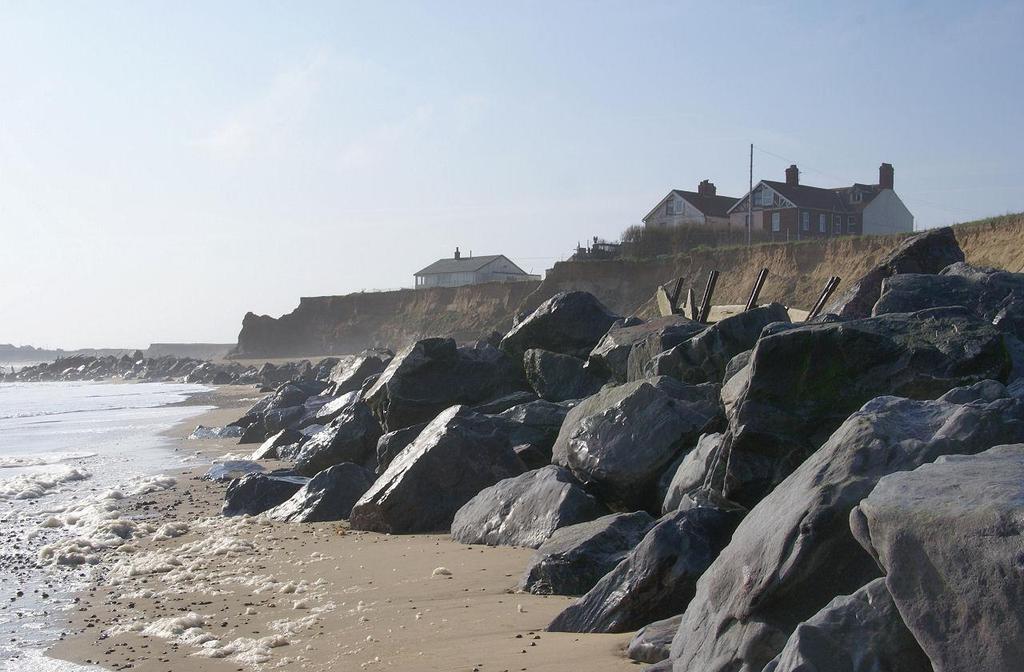 Suggest how the sea defences shown in the photograph will help to protect the coastline (4 marks) Give