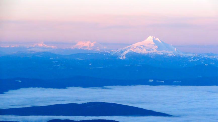 From 9000 feet, the view back to the south as the sun rose was beautiful. We were above the low clouds with an impressive view of Mt. Jefferson, Middle Sister and Broken Top (right to left).