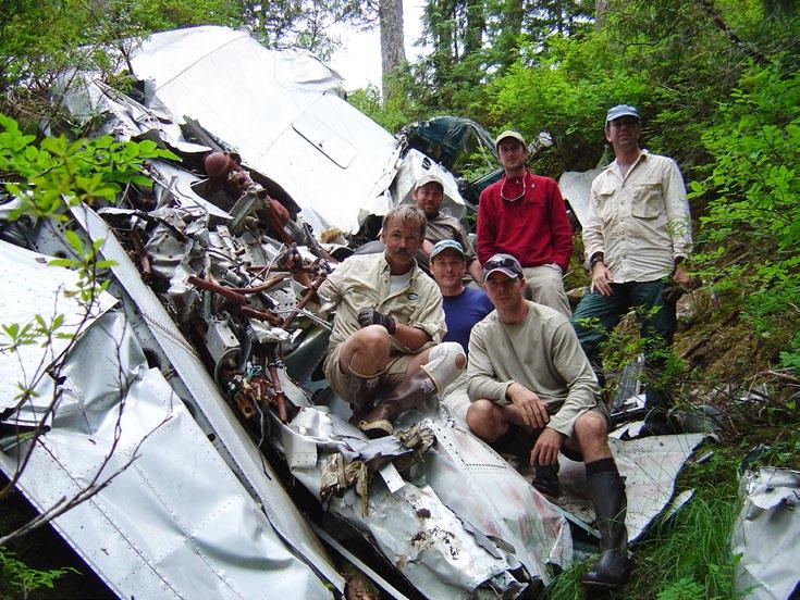The wreckage of c/n 1021 faces uphill behind the TIGHAR / U.S. Forest Service team that surveyed the site in 2003.