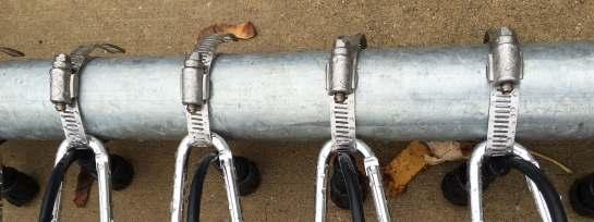 3. Attach the strips to the main structure: About 1 from the top, drill a hole (left to right) through both sides of each 20 ½ PVC conduit. Pass a carabiner through the hole.