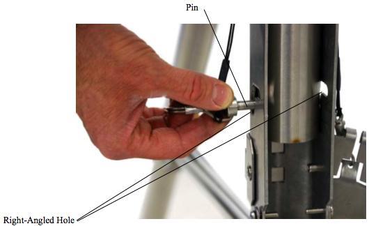 (5) Have one person hold mast section One in the vertical position inside the tripod base, aligning the mast s hole with either