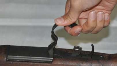 While securing the rifle with one hand, pull rearward and upward on the trigger guard (fig 10 and 11).