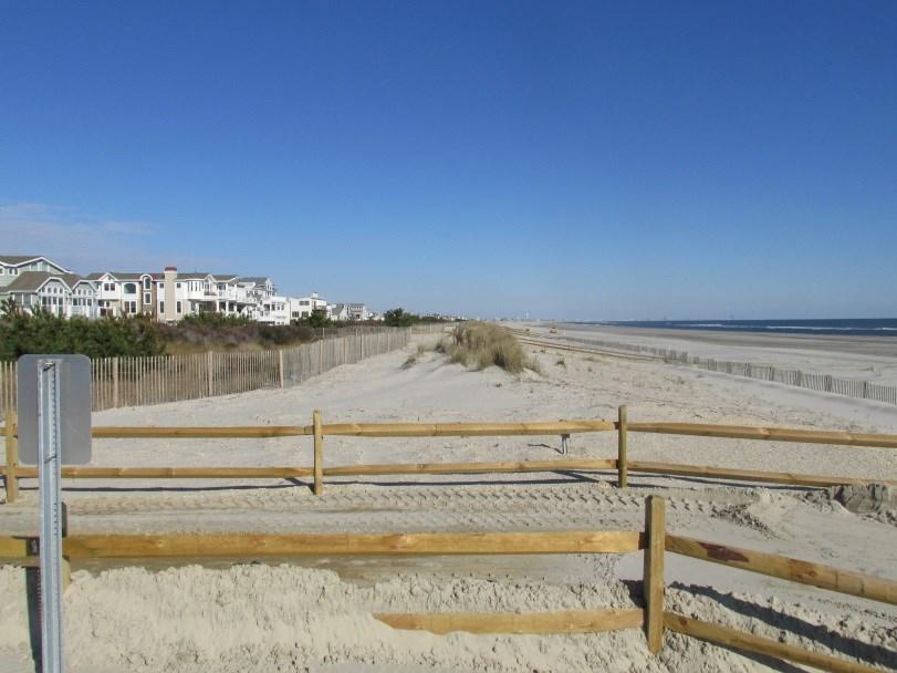 The right photo taken on November 24, 2015, shows the fenced off dune zone located seaward of the original feature with new pedestrian access path fencing installed. Figure 88.