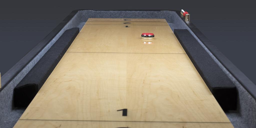 The gutter bumpers are wedged between the playfield and the inside wall of the shuffleboard cabinet to prevent the pucks from gliding off the