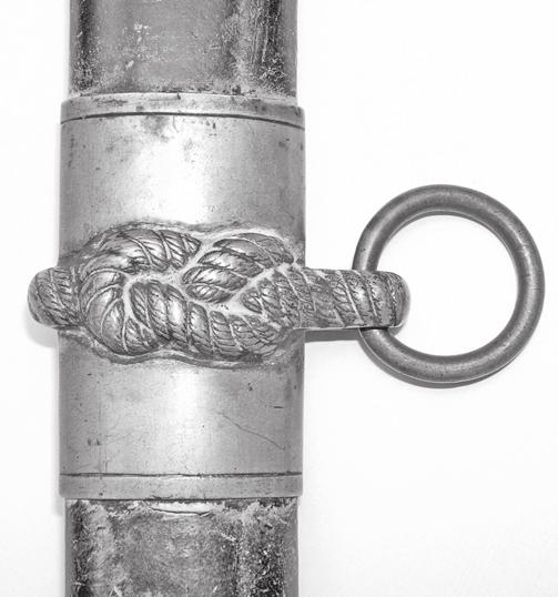 Below that is a stand of arms consisting of a sword, trident, pike, boarding axe, spear and a flag that reads USN. Figure 41. (Sword 12) Fouled anchor on reverse blade.