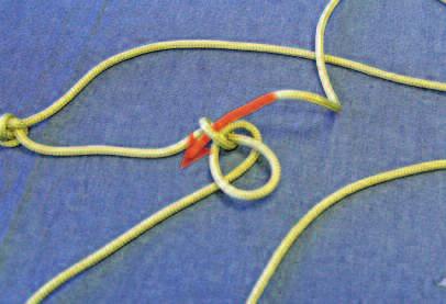 Take the rope and tie a simple overhand knot.