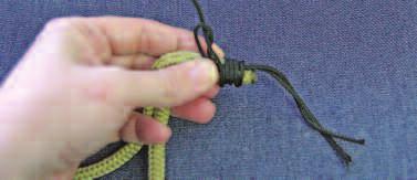 Then pull the end and tighten the knot by pulling on the strands that lead into and out of