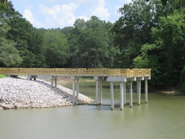 A concrete ramp into the old river run below the dam provides anglers access. A new handicapped accessible pier (below, left) was opened in 217 where the spillway channel and old river run meet.