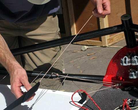 Use the toe straps tensioner rope and thread through each looped end and around the lower front wing