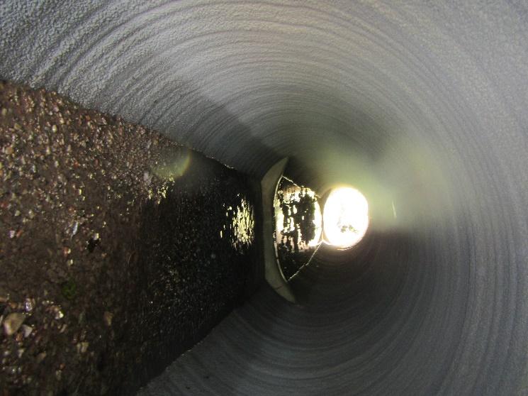 This 6 culvert on this unnamed tributary to the Umpqua River was repaired by applying centrifugally cast concrete. To improve fish passage, concrete culvert weirs were installed with low flow notches.