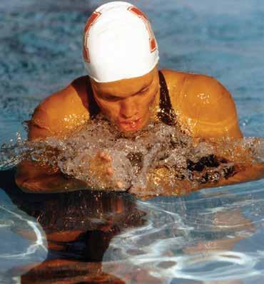 Penny Heyns, a former University of Nebraska standout, earned two gold medals and became the first female in Olympic history to sweep the breaststroke events.