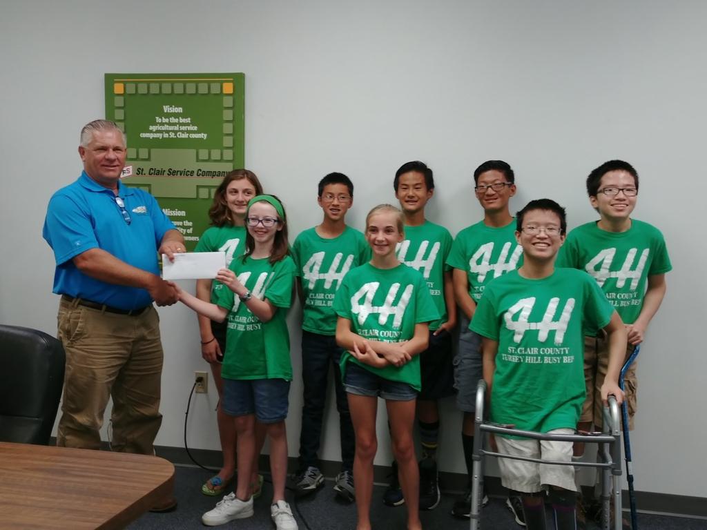 Clair County teens from Turkey Hill Busy Bees 4-H Club receiving a check from, Jim Milleville, St. Clair Service Manager.