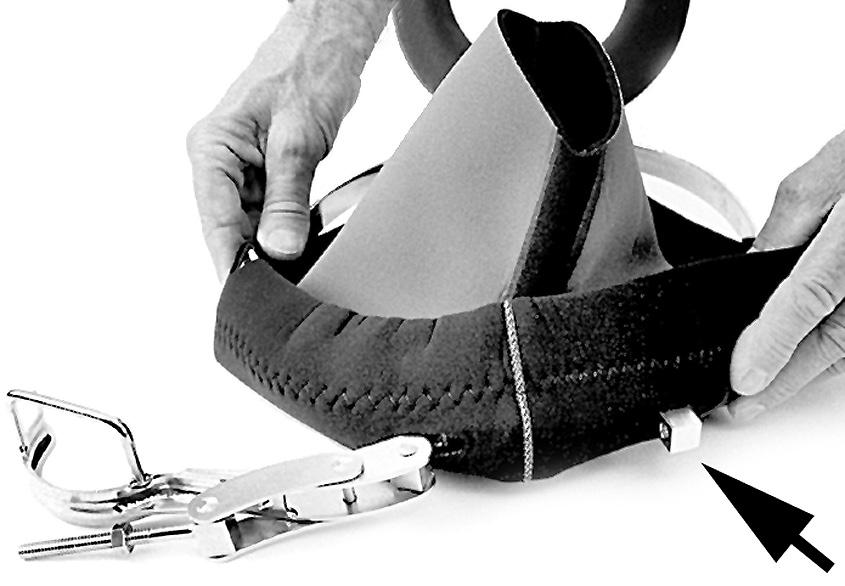 (Rubber side in-cloth out, with the outer edge rolled up towards the clamp). 8) Start feeding the end of the neck clamp without the lever into the large hole of the new neck dam.