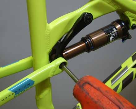 Use the fox guide pin to align and hold the seatstays, dogbone, and shock together.
