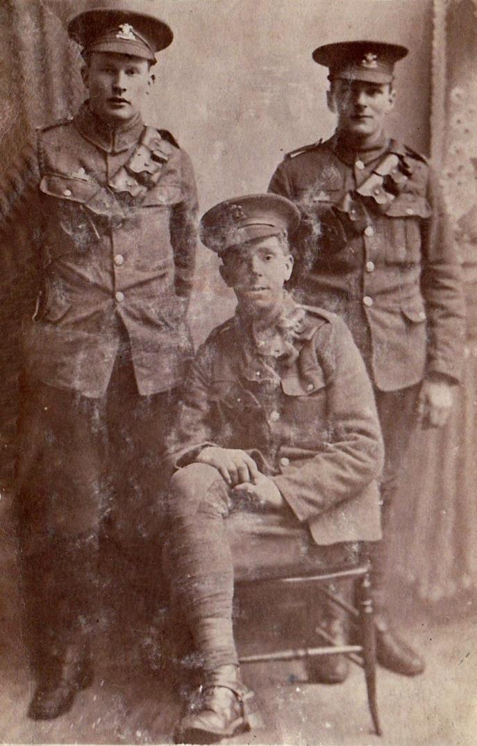 Left to right: Bob Tilston, John Gauterin (sitting), Charlie