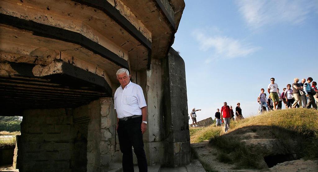 An Italian tourist views a bunker at a strategic site overlooking