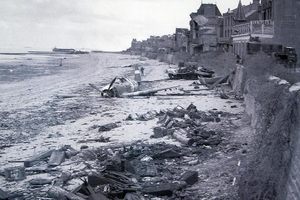 June 194: A crashed US fighter plane is seen on the waterfront some time