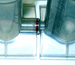 Gently rotate and push-fit the cell inlet adaptor into the sample inlet (marked by a triangle indicating the direction of flow)