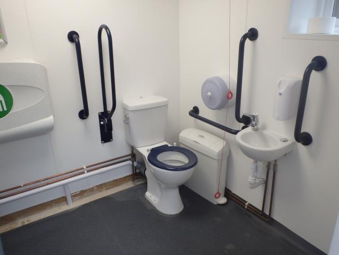 The toilet has a twist lock, lateral transfer space and fitted grab rails.