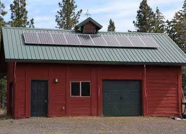 adjacent to the cabin and houses the solar panels for the