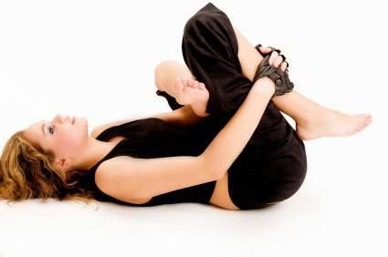 For a deeper stretch place your hands just below the knee of the bottom leg. As you hold, make sure that you head is relaxed on the mat.