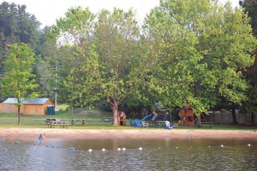 friendly swimming area, raft, picnic tables, play structures, beach volleyball