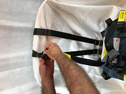 Then pull the harness strap out of the top of the
