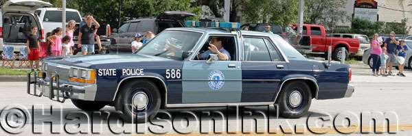 A classic visiting state police vehicle is shown.