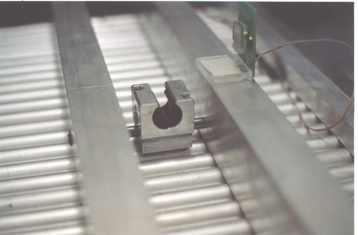 For the single point support a standard mounting block housing has been modified to allow for the sliding support on a steel rod. This is shown in a close-up view in Figure 4.