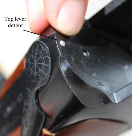 8. Rotate the top lever to the right to open the action. 9. While holding the top lever to the right, rotate the barrel assembly downward and remove it from the receiver. 10.