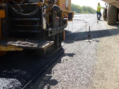 Figure 5 Pavement installed using the tried and true String Line method Figure 6 Verifying pavement thickness prior to rolling.