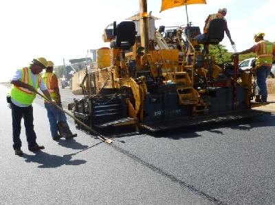 A straight edge and tape measure was used intermittently to check the asphalt concrete lift before compacting.