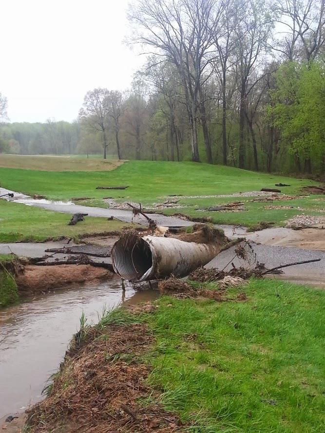 The course received 7.5 of rain in within three days over April 28, 29 ad 30. The flood waters eroded the soil alongside a large drain pipe causing a section of cart path to collapse.
