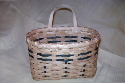 It has a filled base and features 10 leather handles. You will find many uses for this basket. Extra kits are available. Cost: $37 for two, one green, one burgundy.