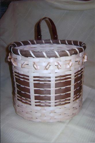 base and leather handle. Use as bag dispenser, has a 2 ½ hole in base. Use as basket or waste basket.