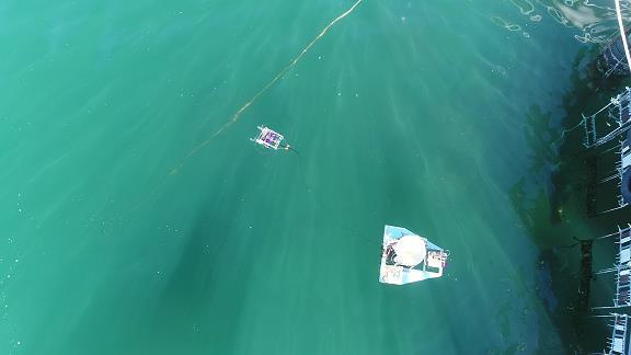 using a multi-copter. Although the multi-copter is a powerful tool for our purpose, we needed to add underwater monitoring function.