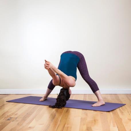 7. Wide-Legged Forward Bend C From Bound Extended Side Angle, unclasp your hands, straighten your right leg, and inhale to stand up. Exhale to adjust both feet, so your toes are pointing in.